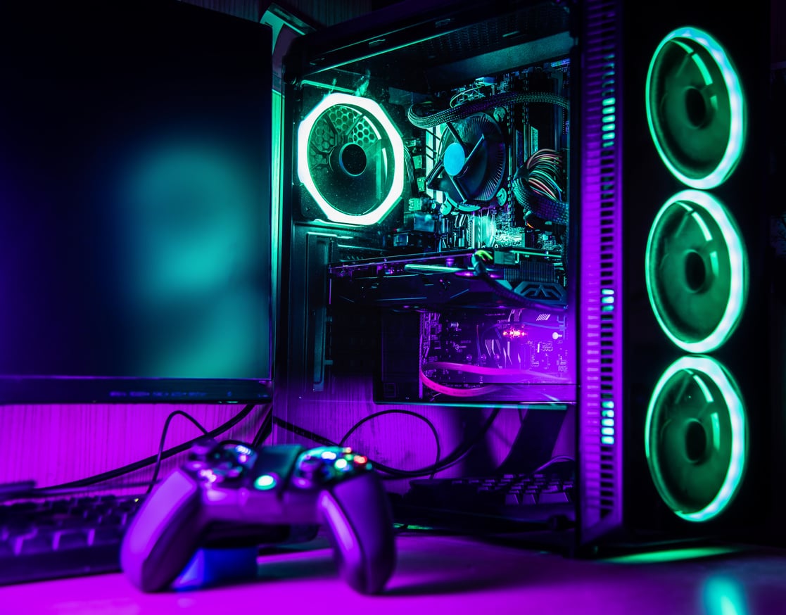 Game controller and pc rgb case on a wooden desk